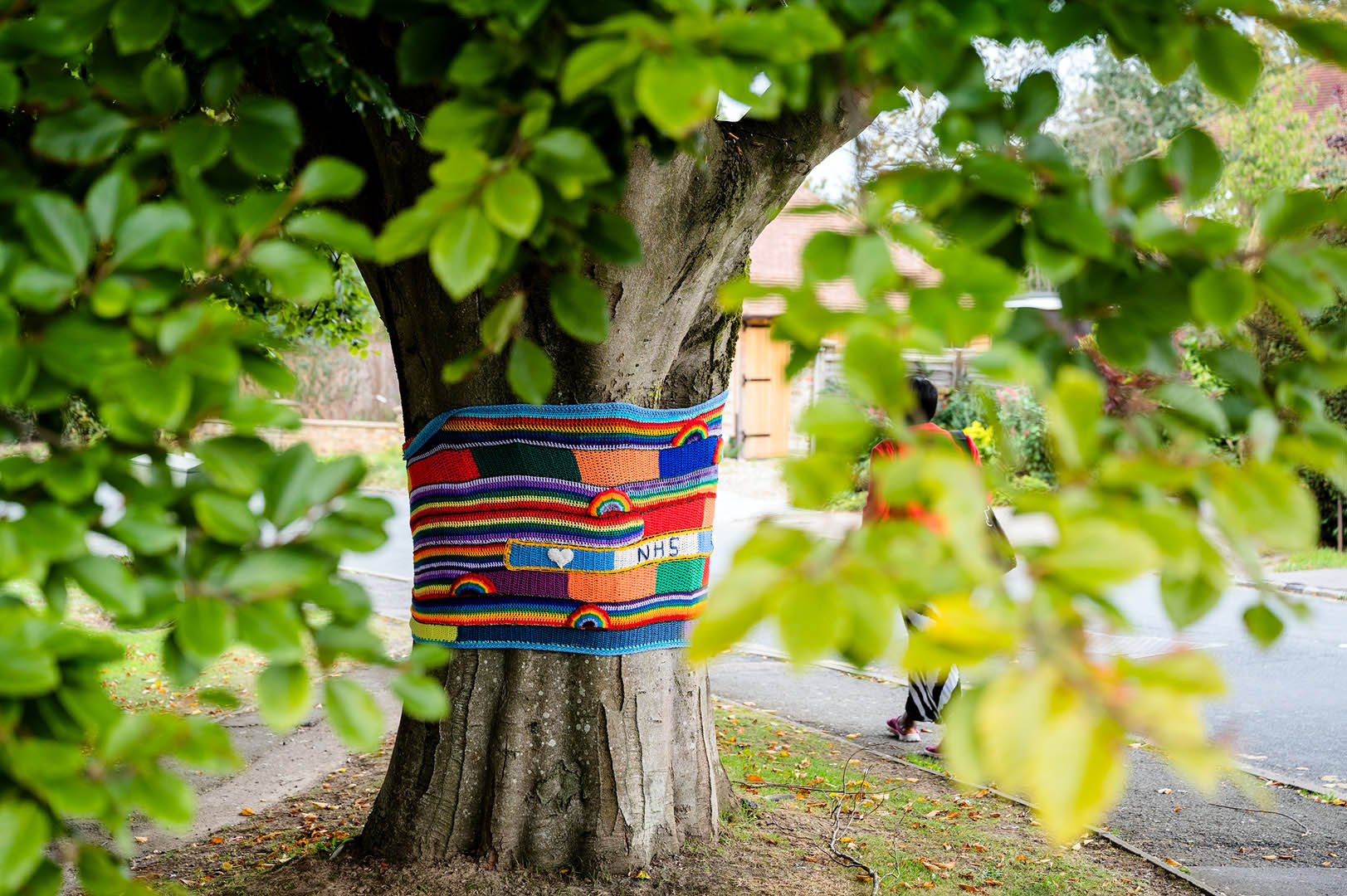 Tree wrapped in banner made from scarves and rainbows previously seen around Prestwooid in Buckinghamshire during lockdown