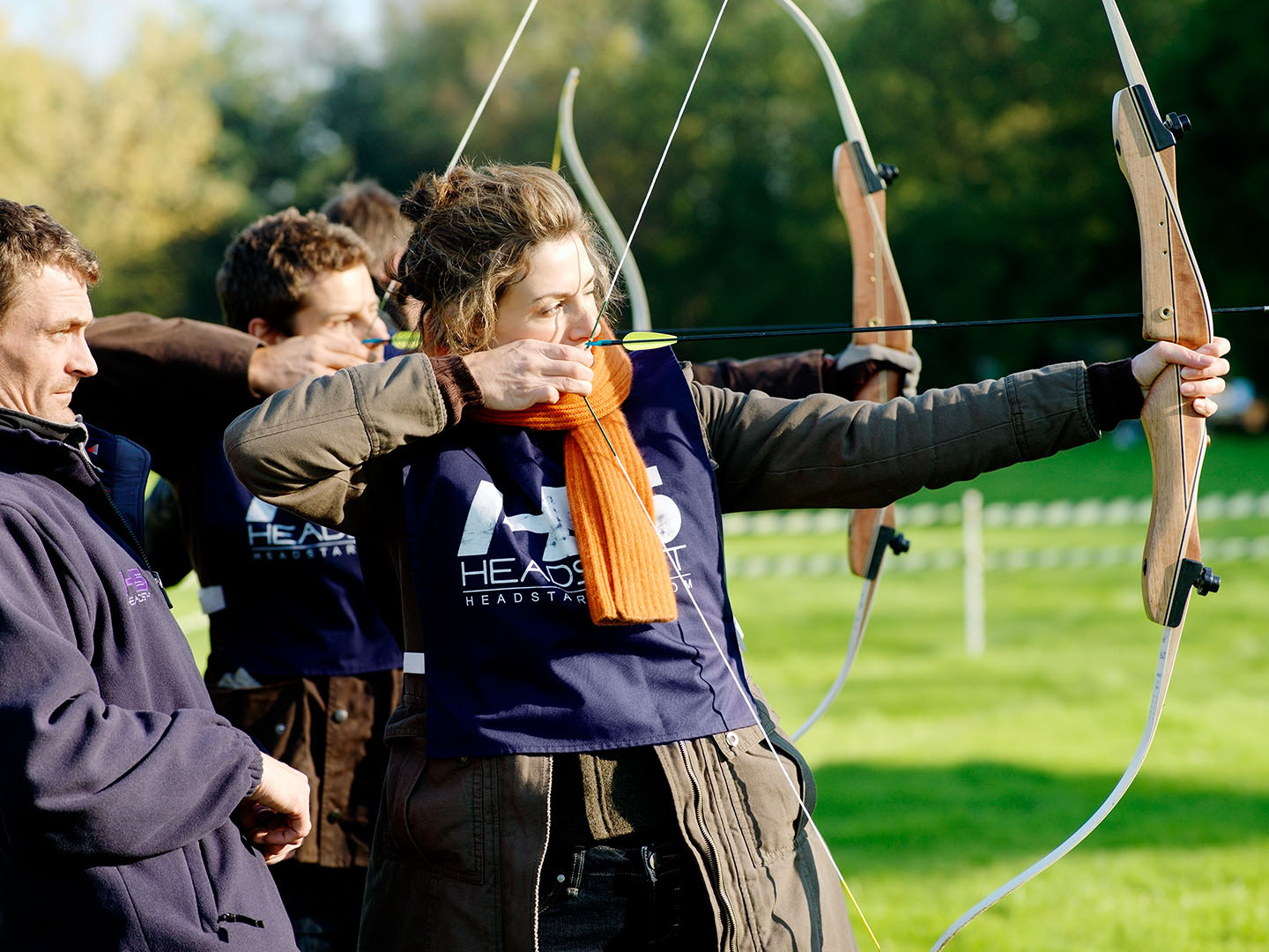 Close up of woman having Archery tuition at Corporate event