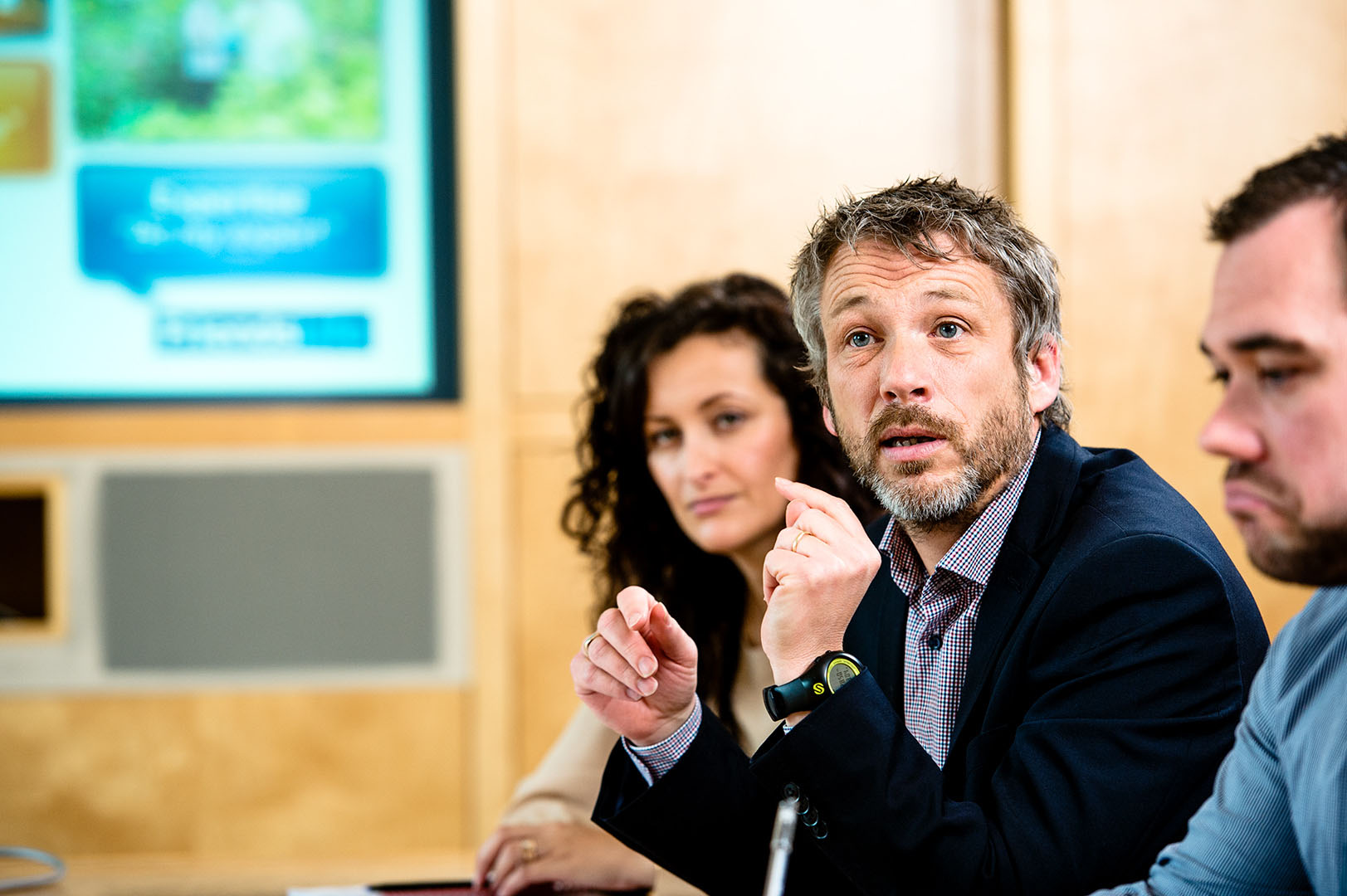 Man gesturing with hands to make a point in business meeting