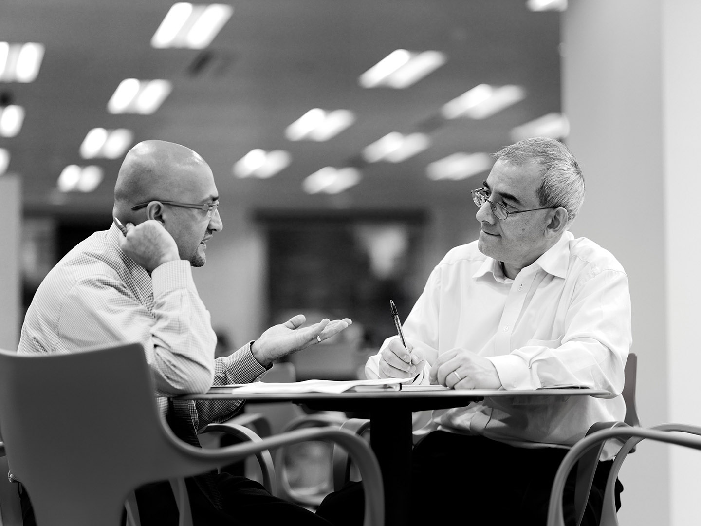 Informal break out meeting with two male colleagues in discussion