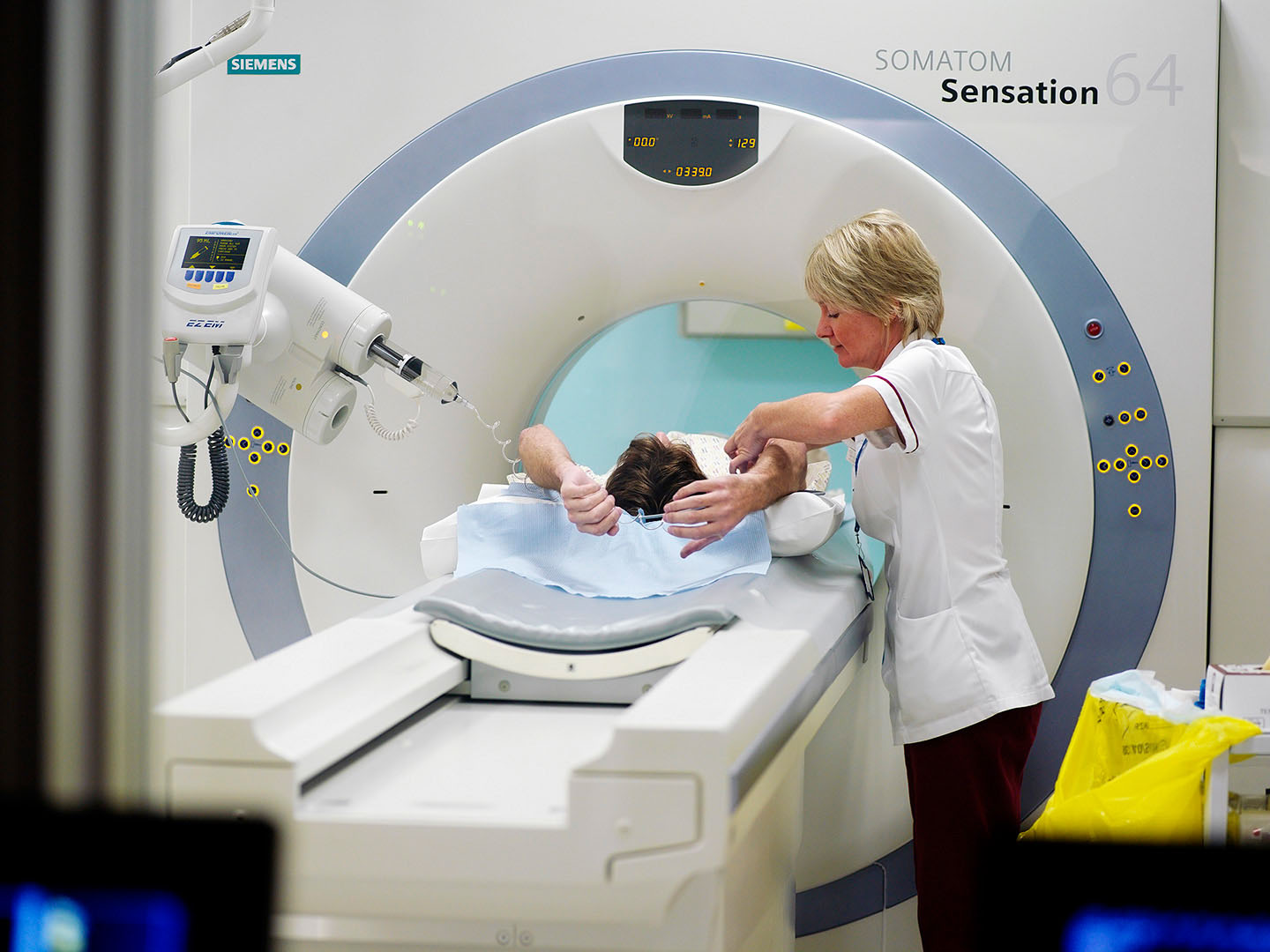 Radigrapher with patient preparing for CT Scan
