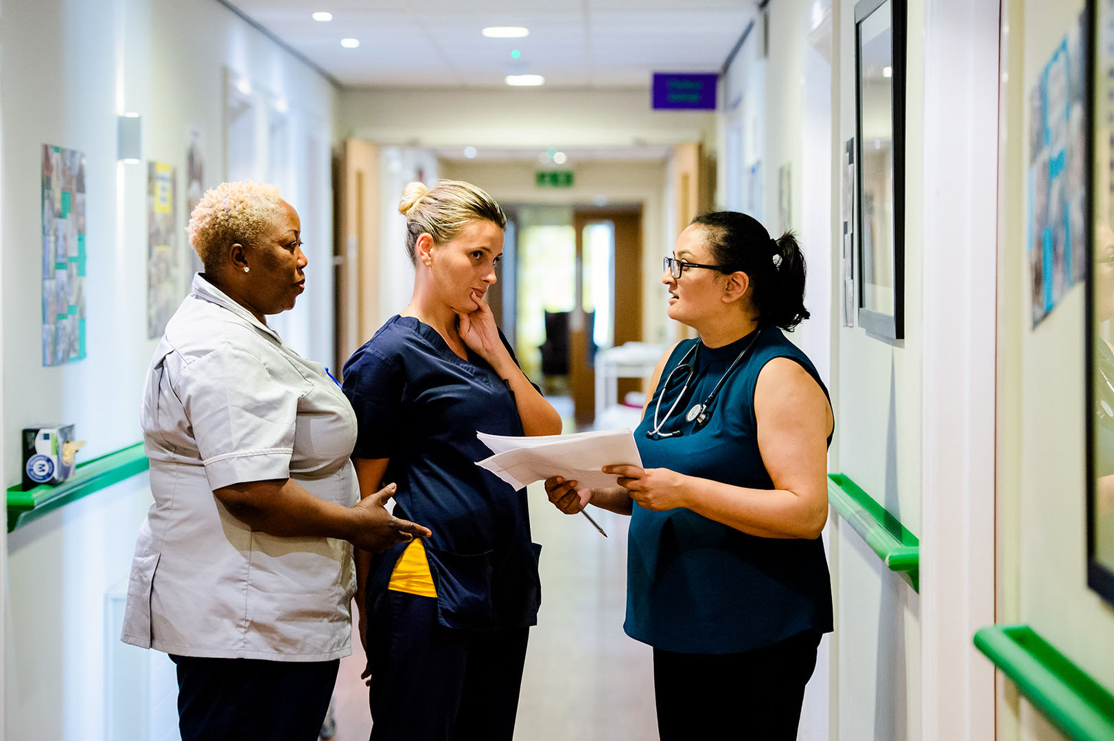 Doctor in discussion with Care Home staff in corridor