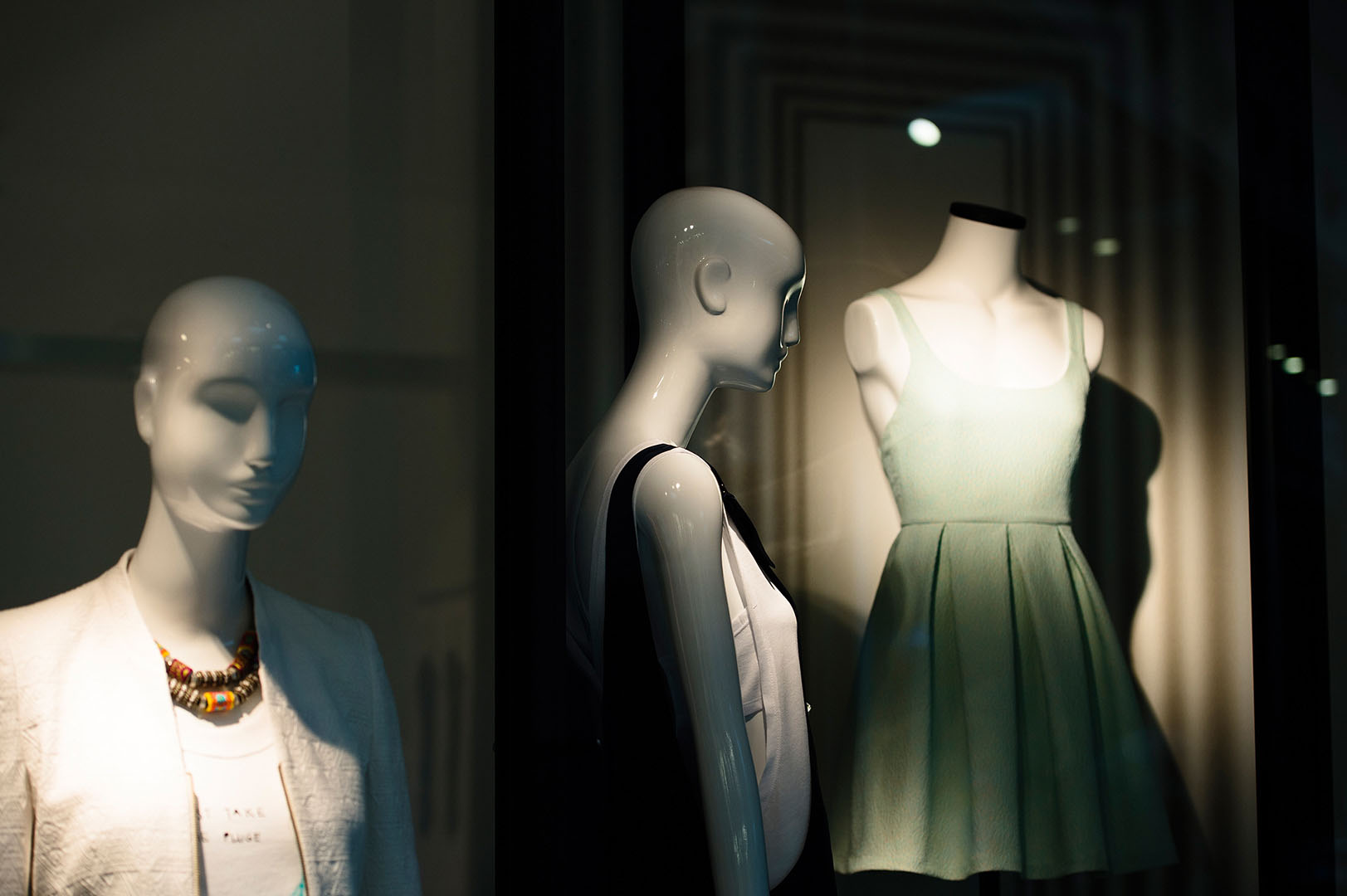 Moodily lit mannequins in shop window