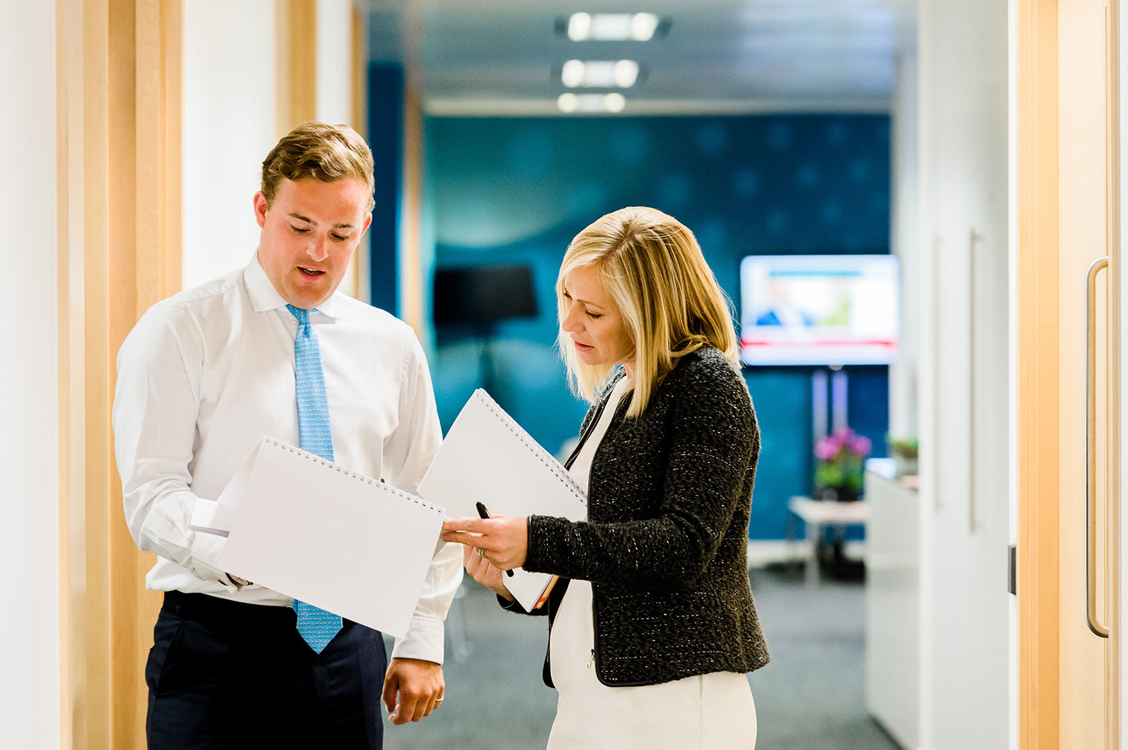 Man and Woman in conversation in office corridor