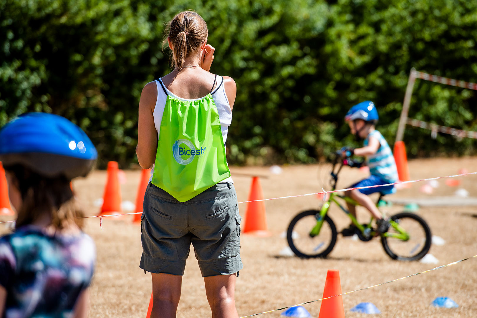 Mother watching her son on Mountain bike course