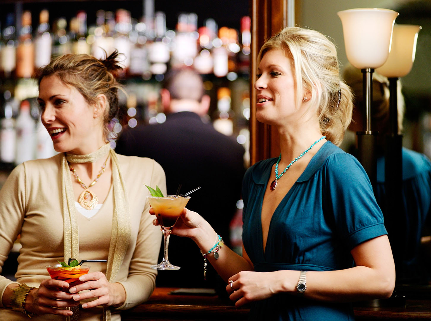 Two women drinking cocktails
