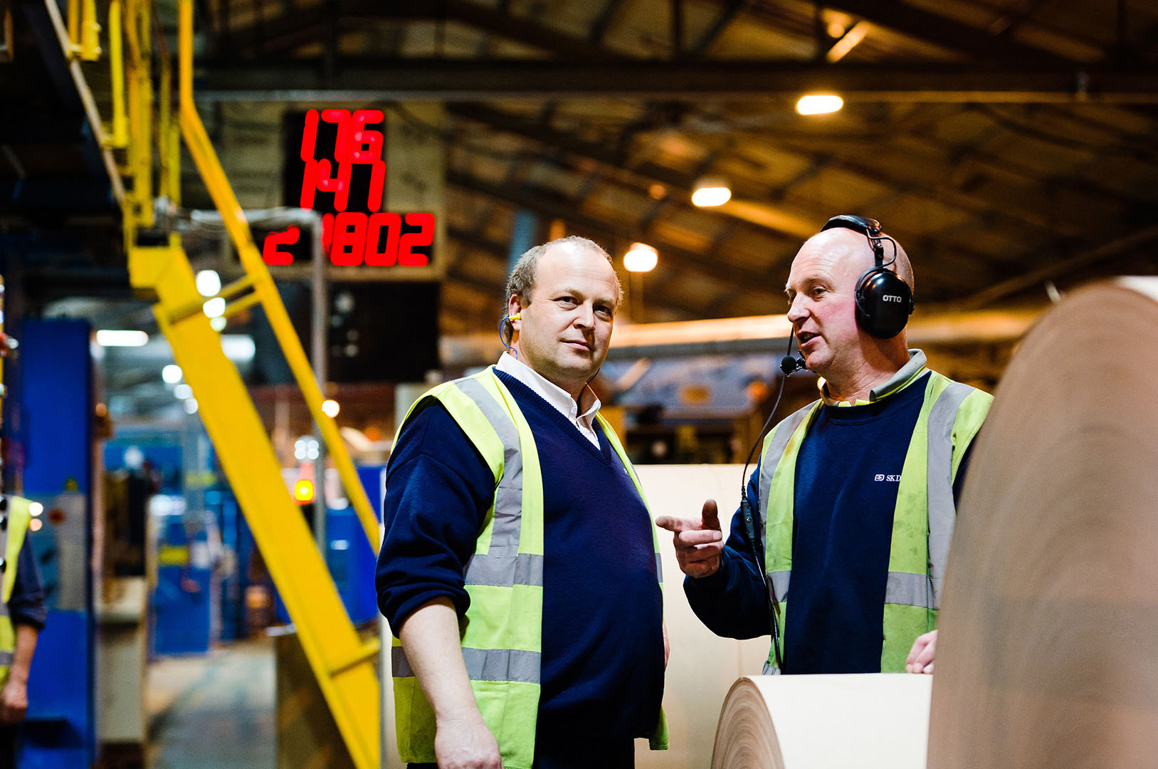 Two workers in Hi-Vis vests in conversation in Paper Mill
