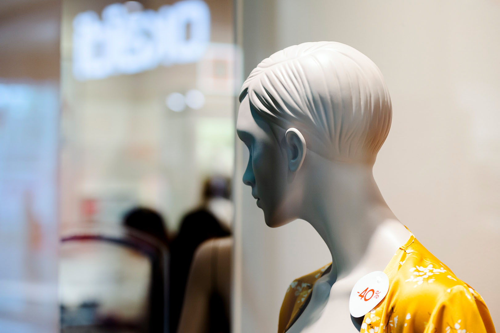 Mannequin turning away looking left of frame