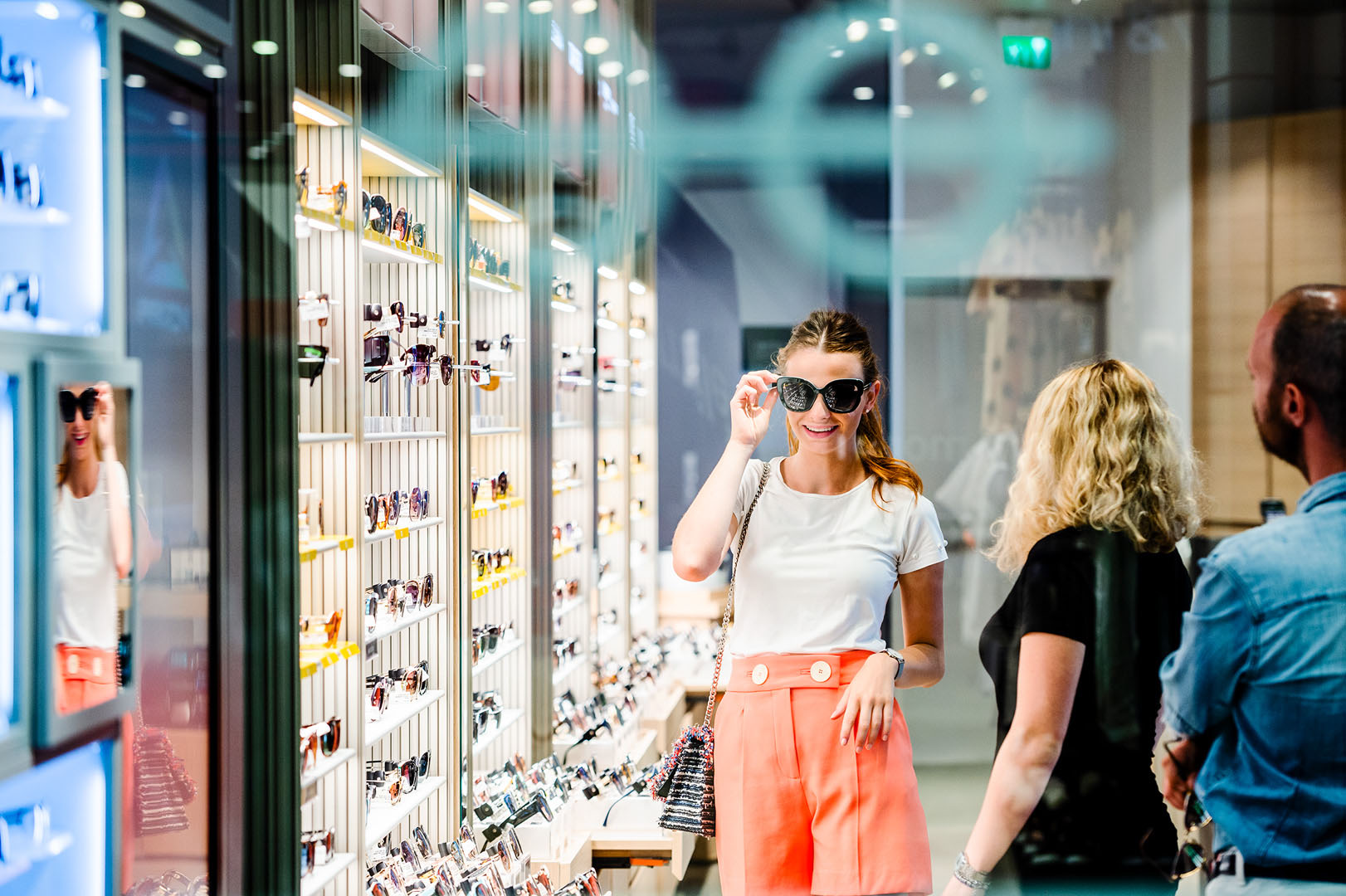 Woman trying on sunglasses in retail setting