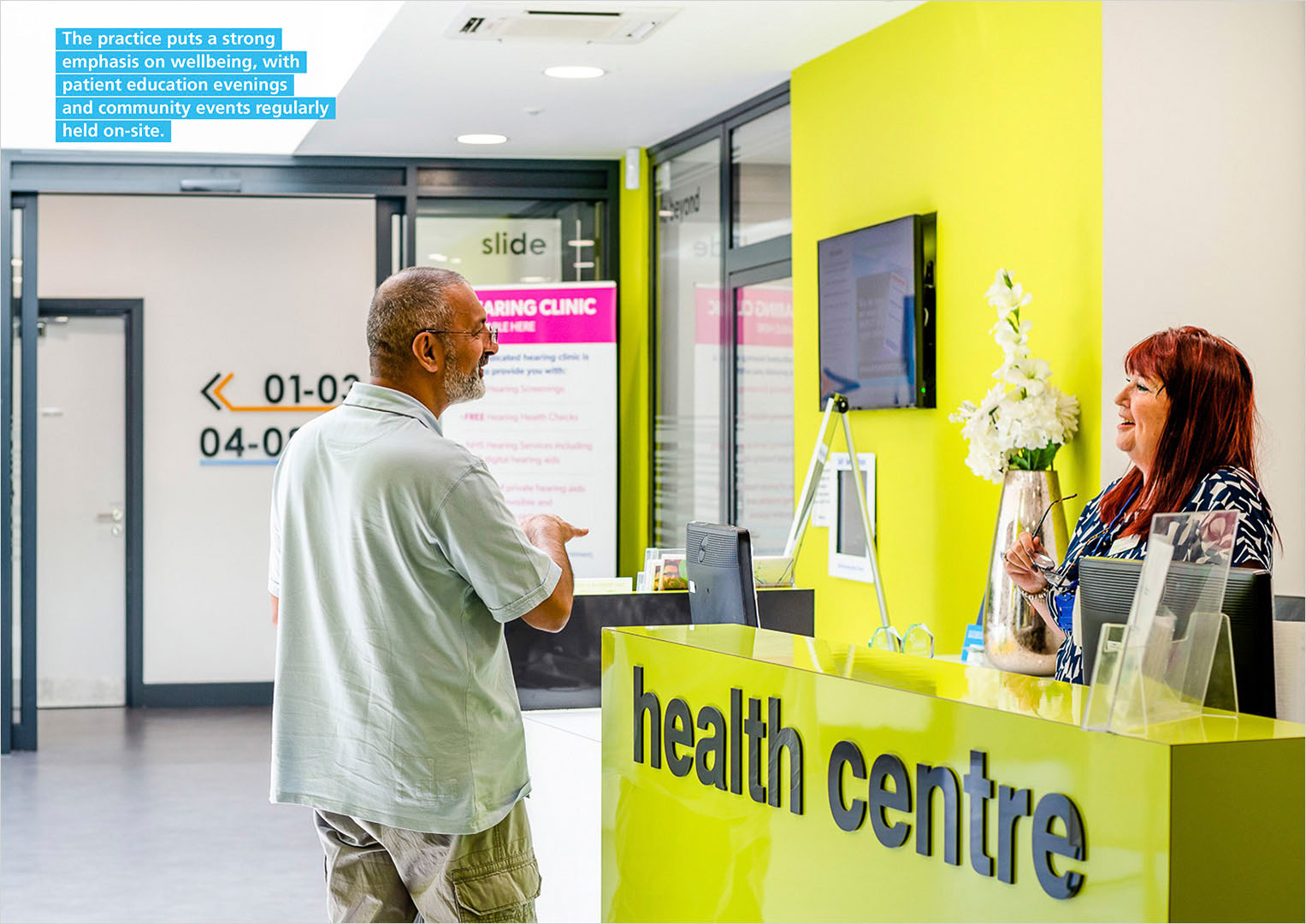 Spread from NHS Brochure featuring Health Centre receptionist in conversation with patient