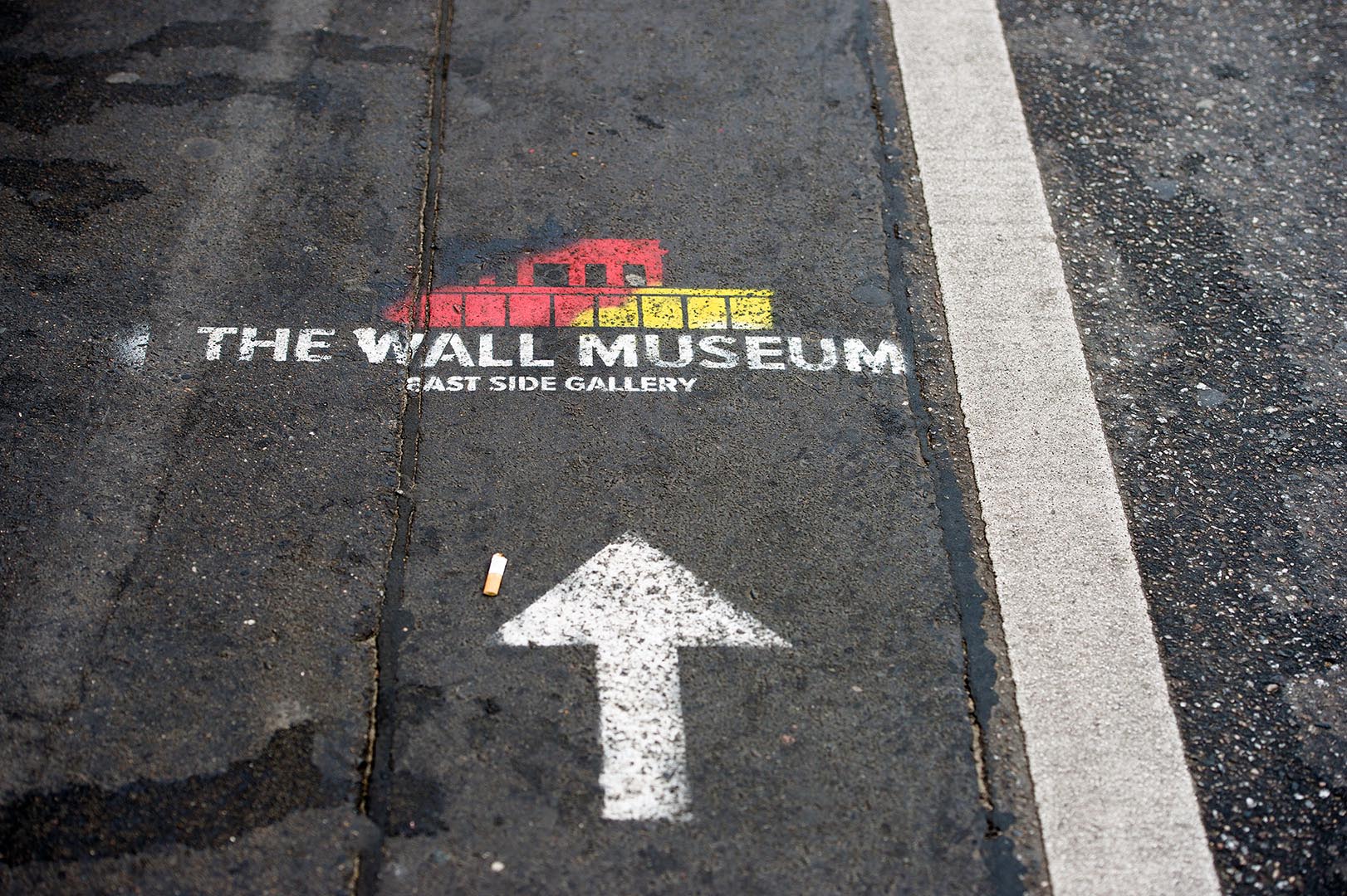 This way to The Wall Museum - Stencil on Berlin pavement