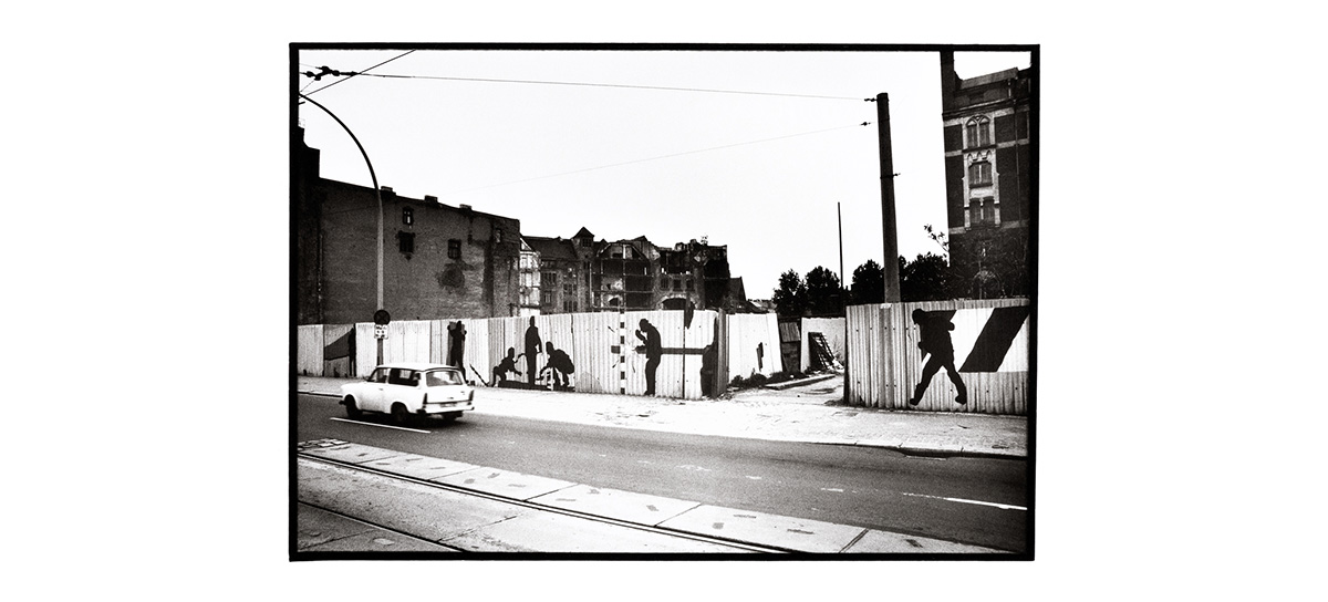B&W shot of construction site perimeter artwork from 1987