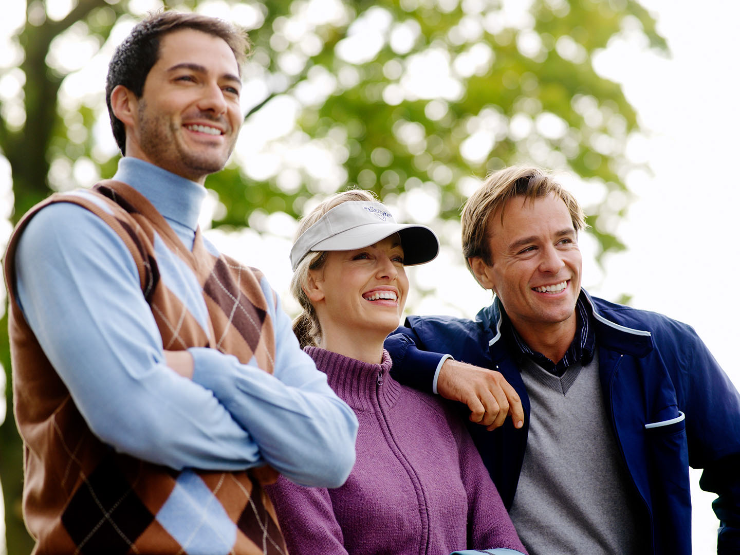 Close up of 3 golfers looking off camera