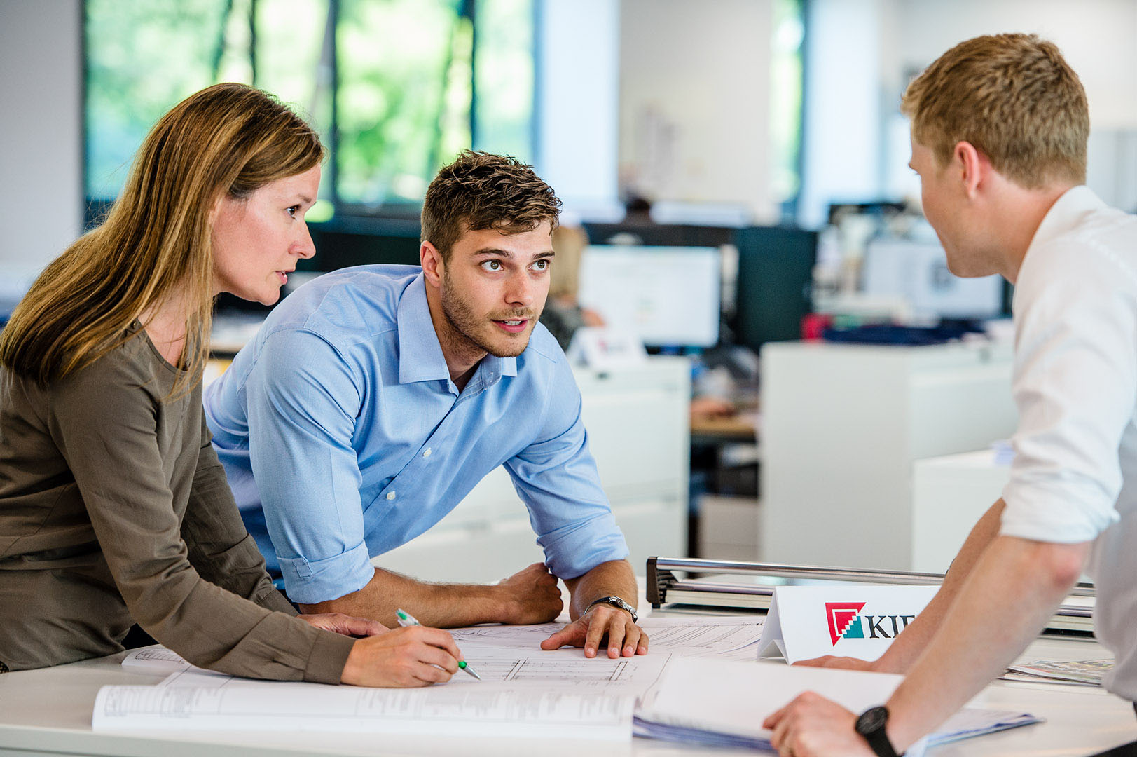 Three people in strategy meeting in Property developers office