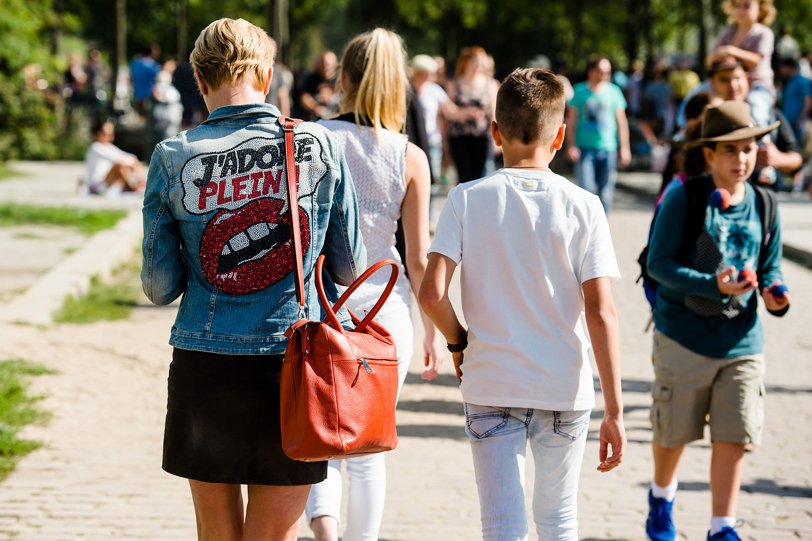 Girl walking in Mauerpark Berlin with artwork on Denim Jacket