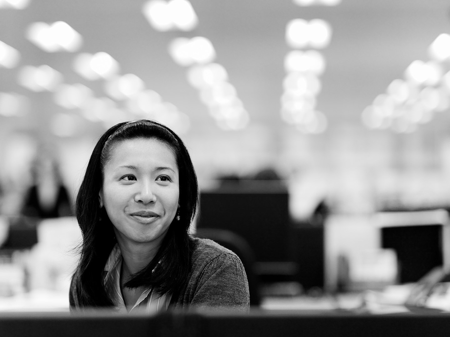 Woman on reception with office background with dynamic out of focus ceiling lights