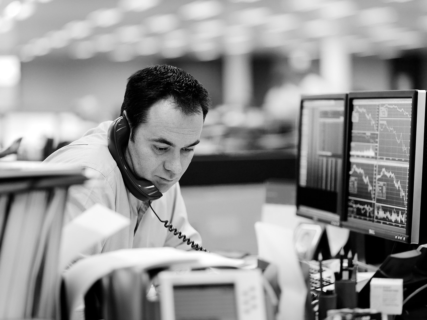 Male trader on the phone at city trading desk