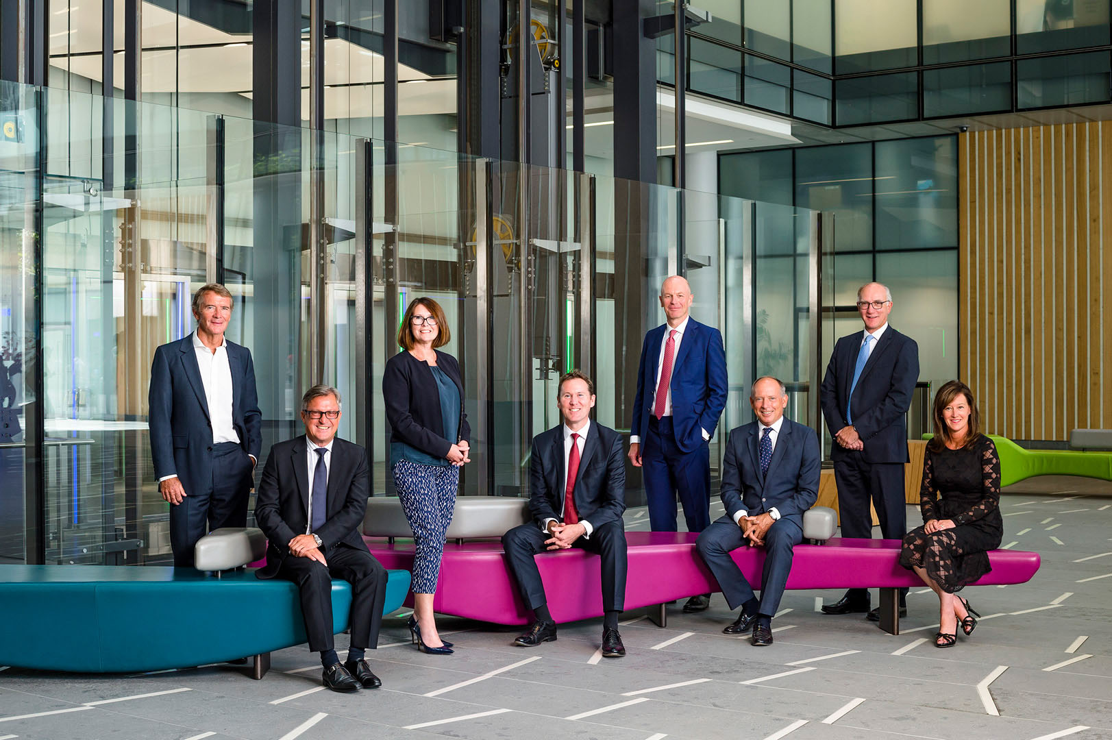 Board Group seated & standing in reception area of corporate HQ