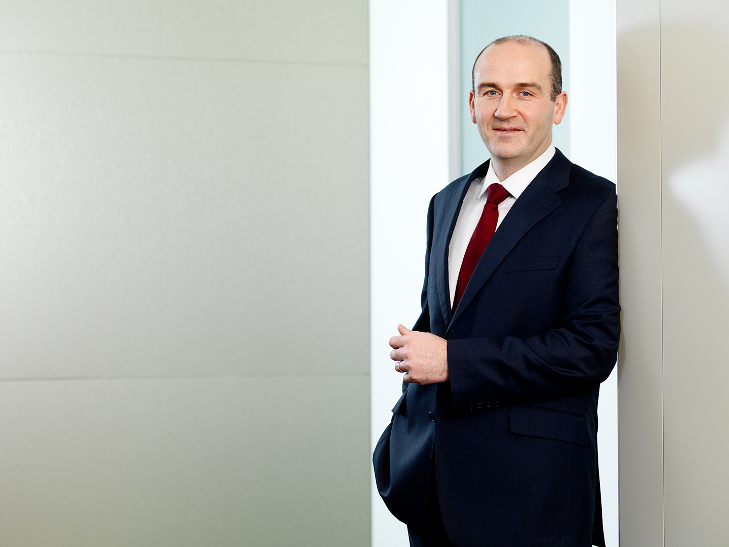 Male director in suit standing and looking to camera