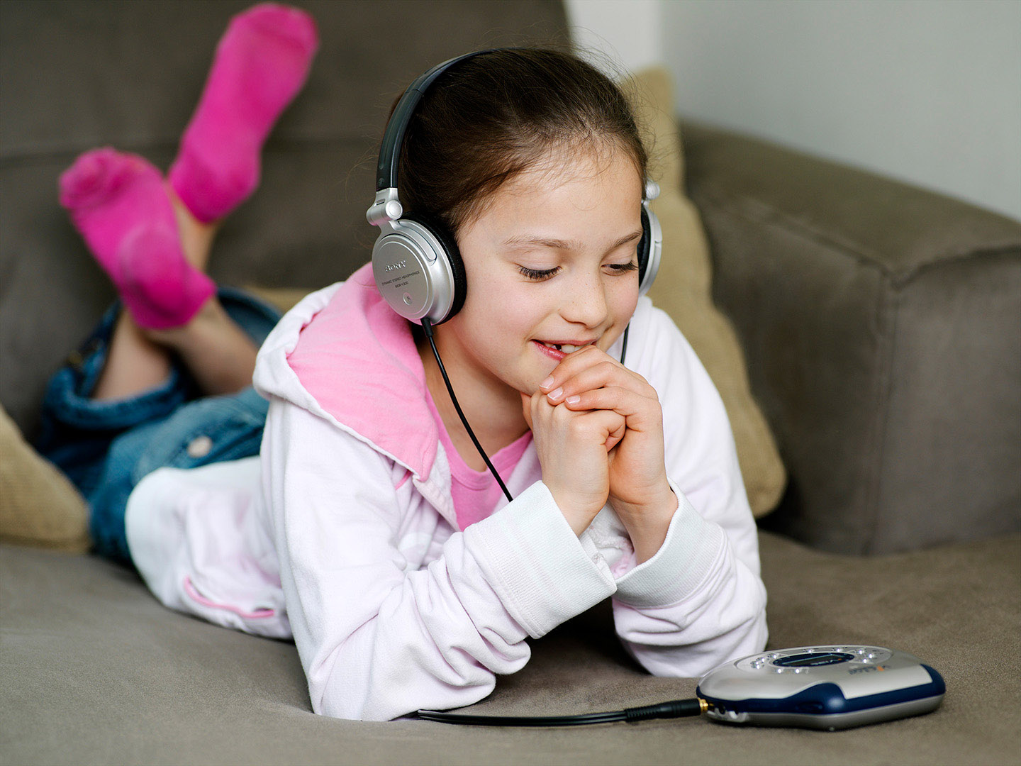 Young girl listening to music on headphones
