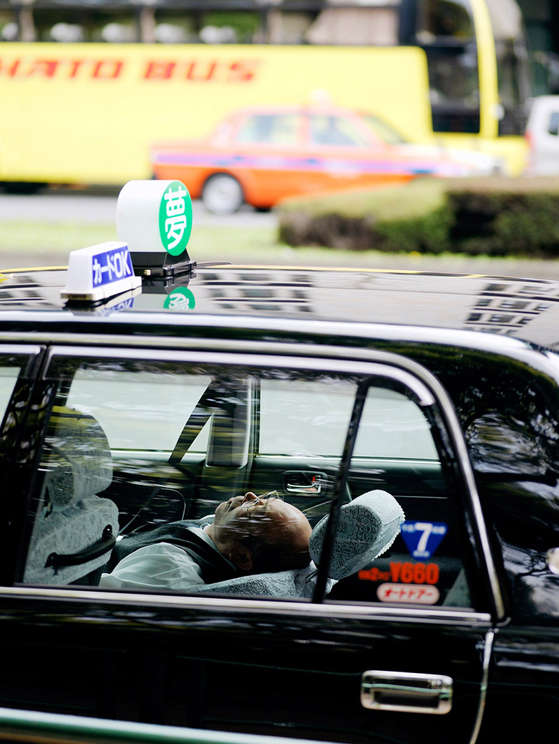 Tokyo taxi driver taking a nap in cab