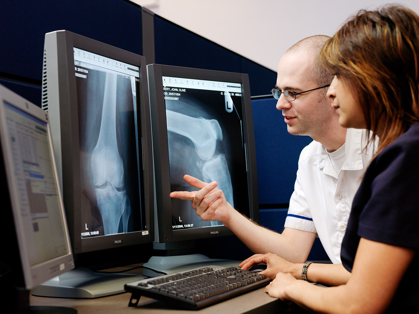 Asian Nurse & Radiographer in  discussion about Long Bone X-rays on screen