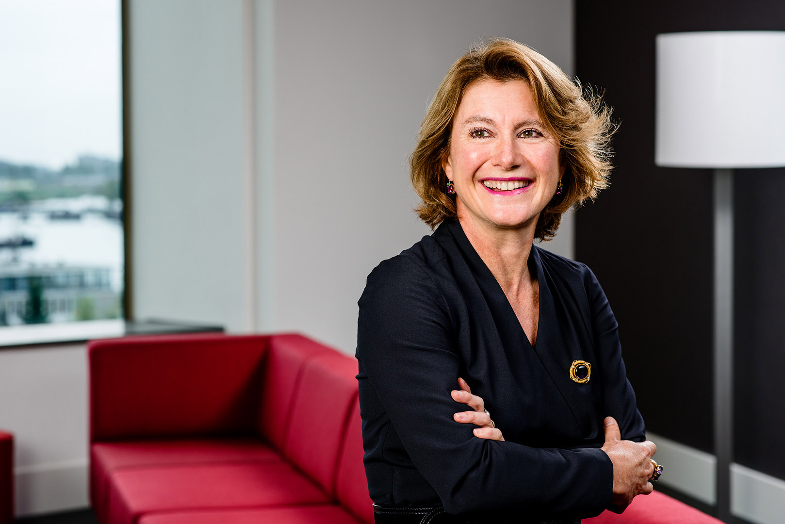 Female businesswoman seated and looking back over shoulder off camera