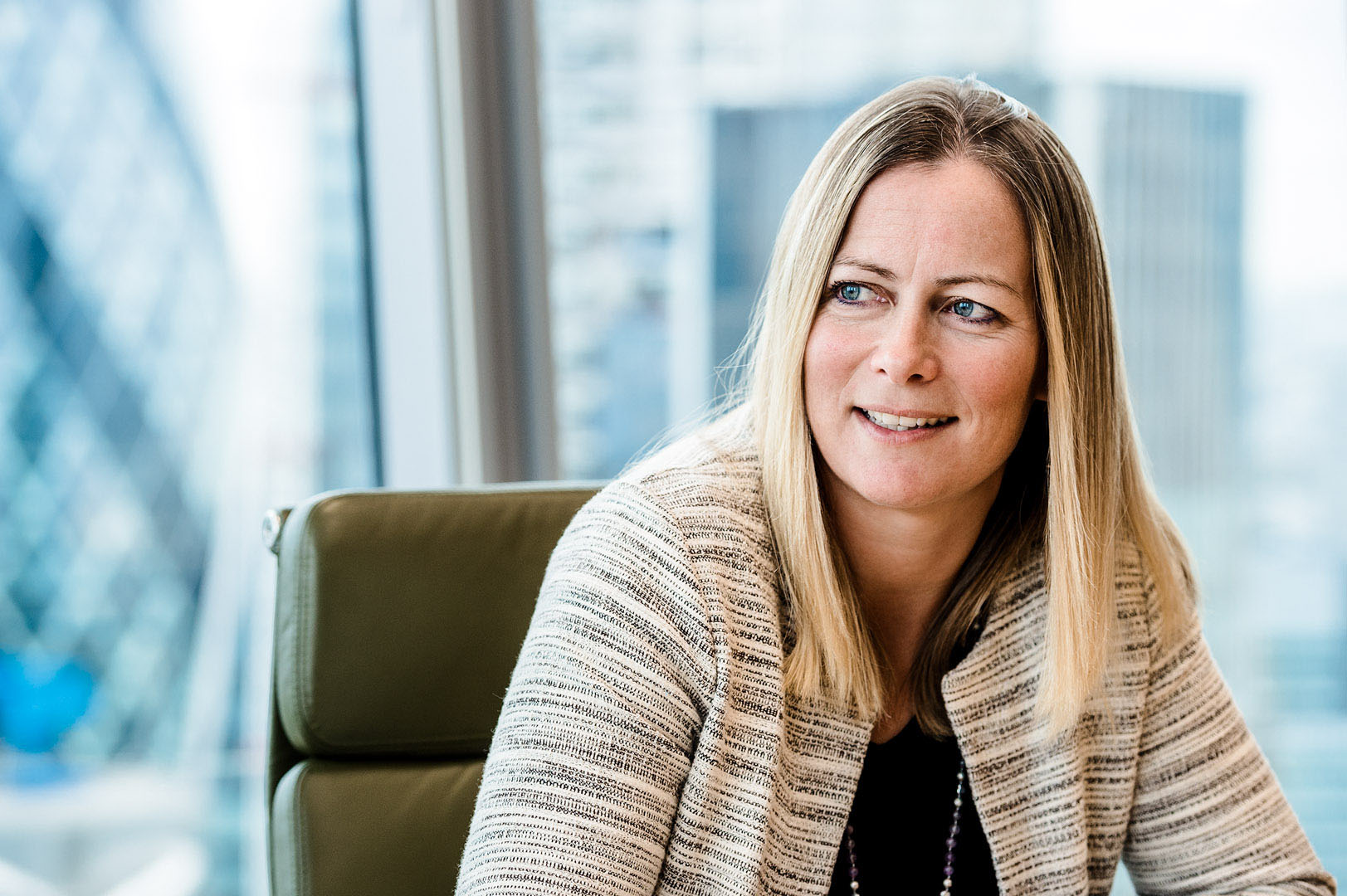 Female director looking off camera with view of the Gherkin in the background