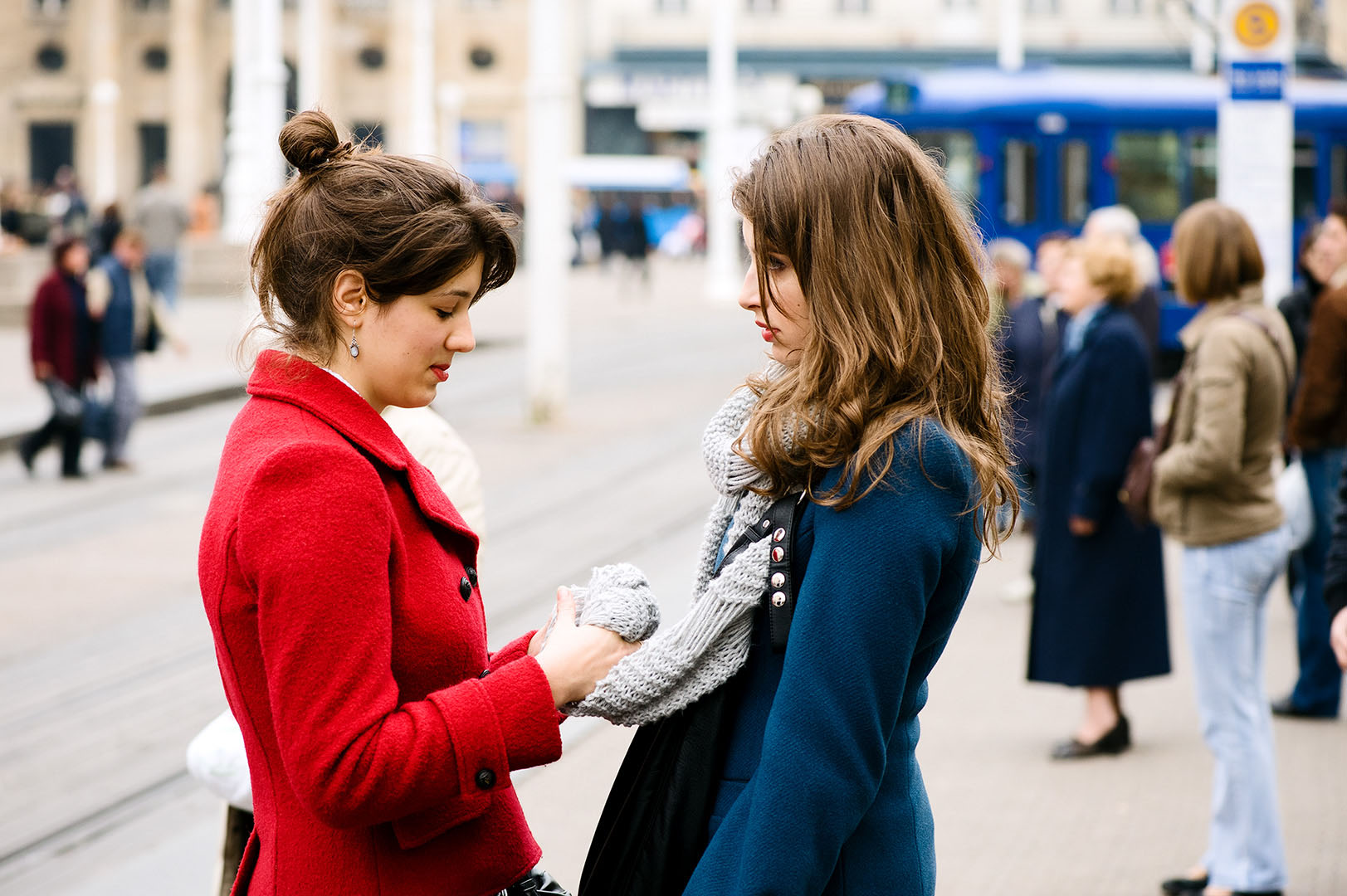Two women at tramstop in Eastern European street scene