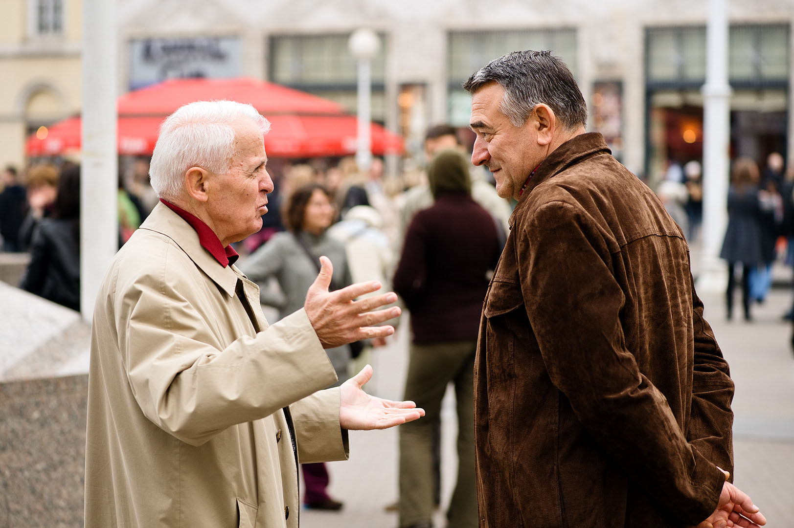 Two older men in conversation in Eastern European street scene