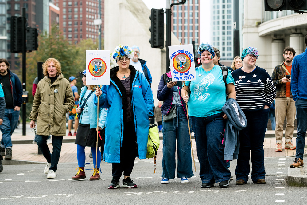 Wild swimmers with placards on the way to join March for Clean Water in Westminster