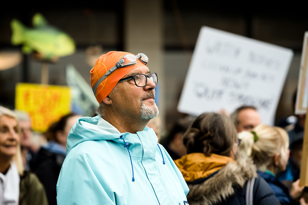 Wild swimmer listening to speakers at River Action demo in Westminster