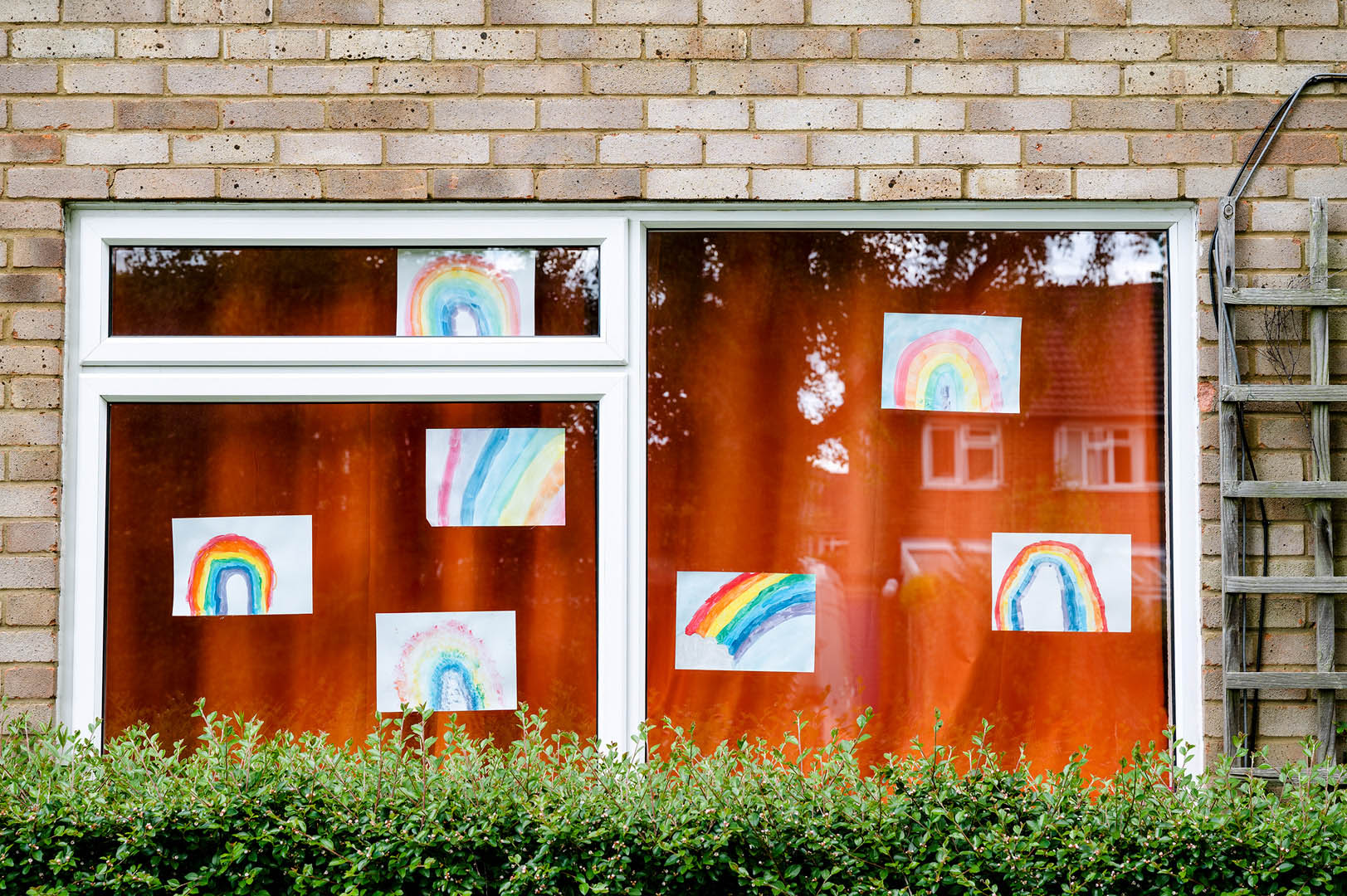 Random rainbow drawings on window during Lockdown