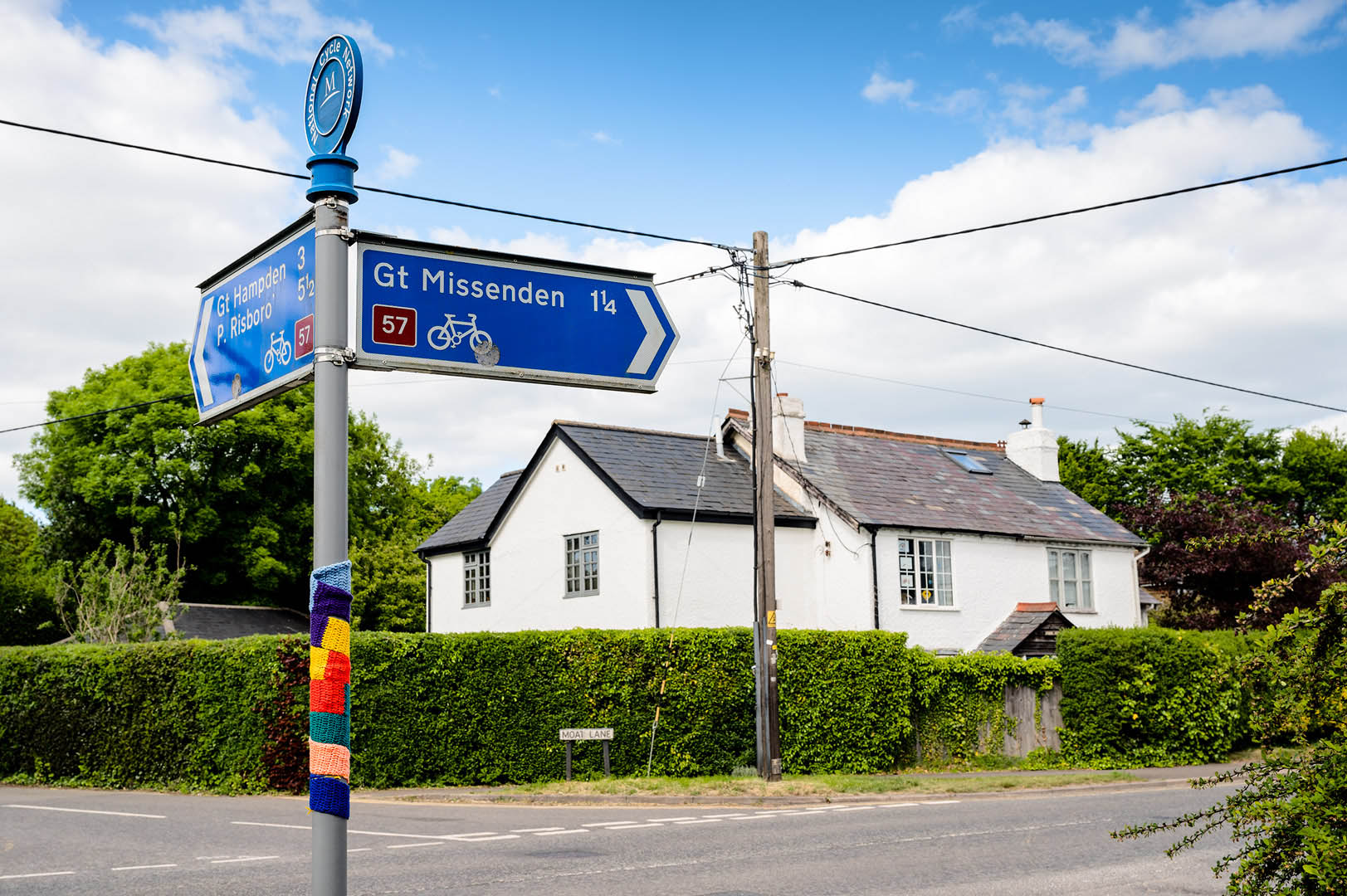 Cycle route signage adorned with rainbow scarf during lockdown