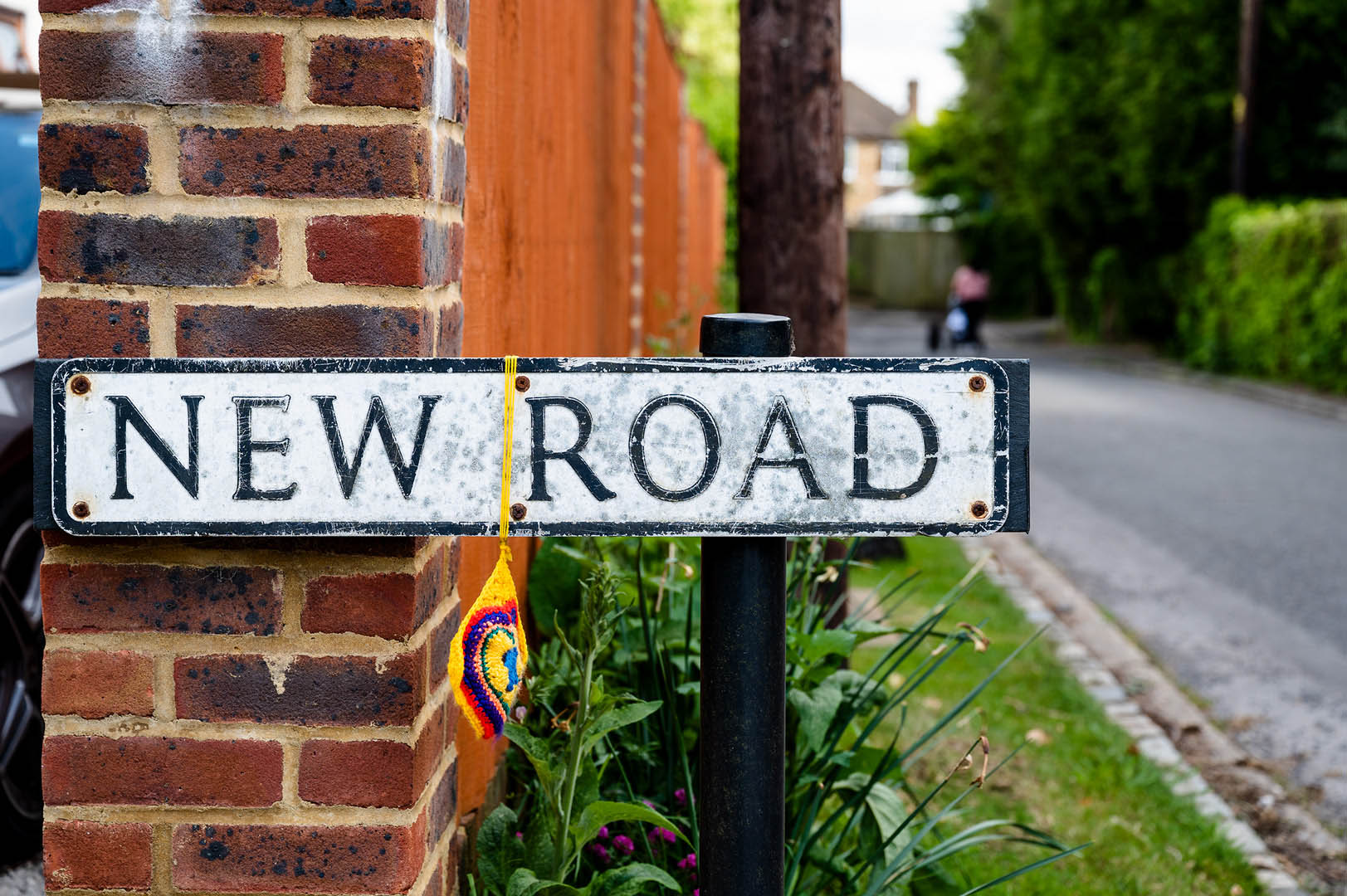 Rainbow decoration on roadsign during lockdown
